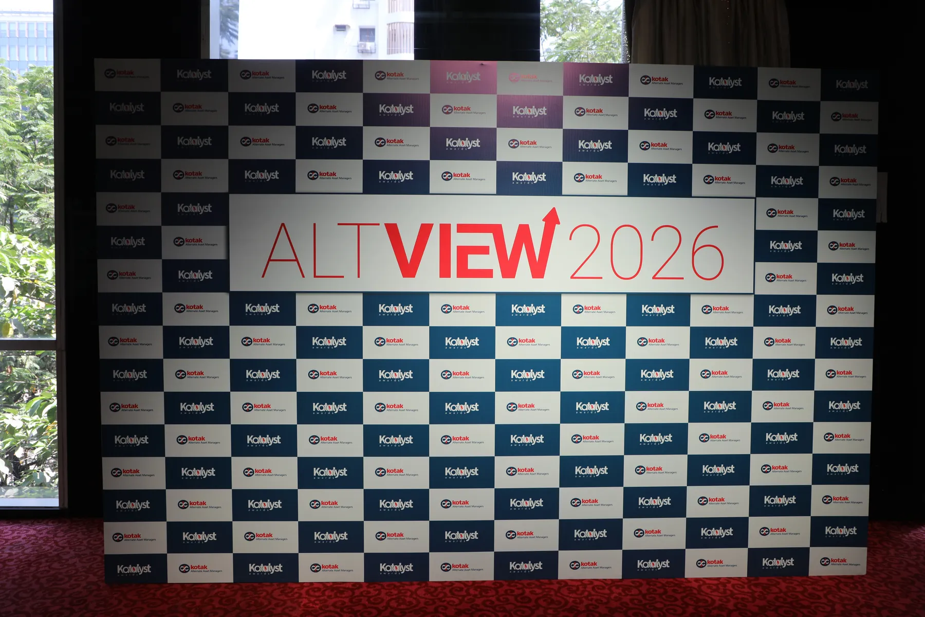A Kotak Katalyst Awards ALTVIEW 2026 branded backdrop wall in a hall.