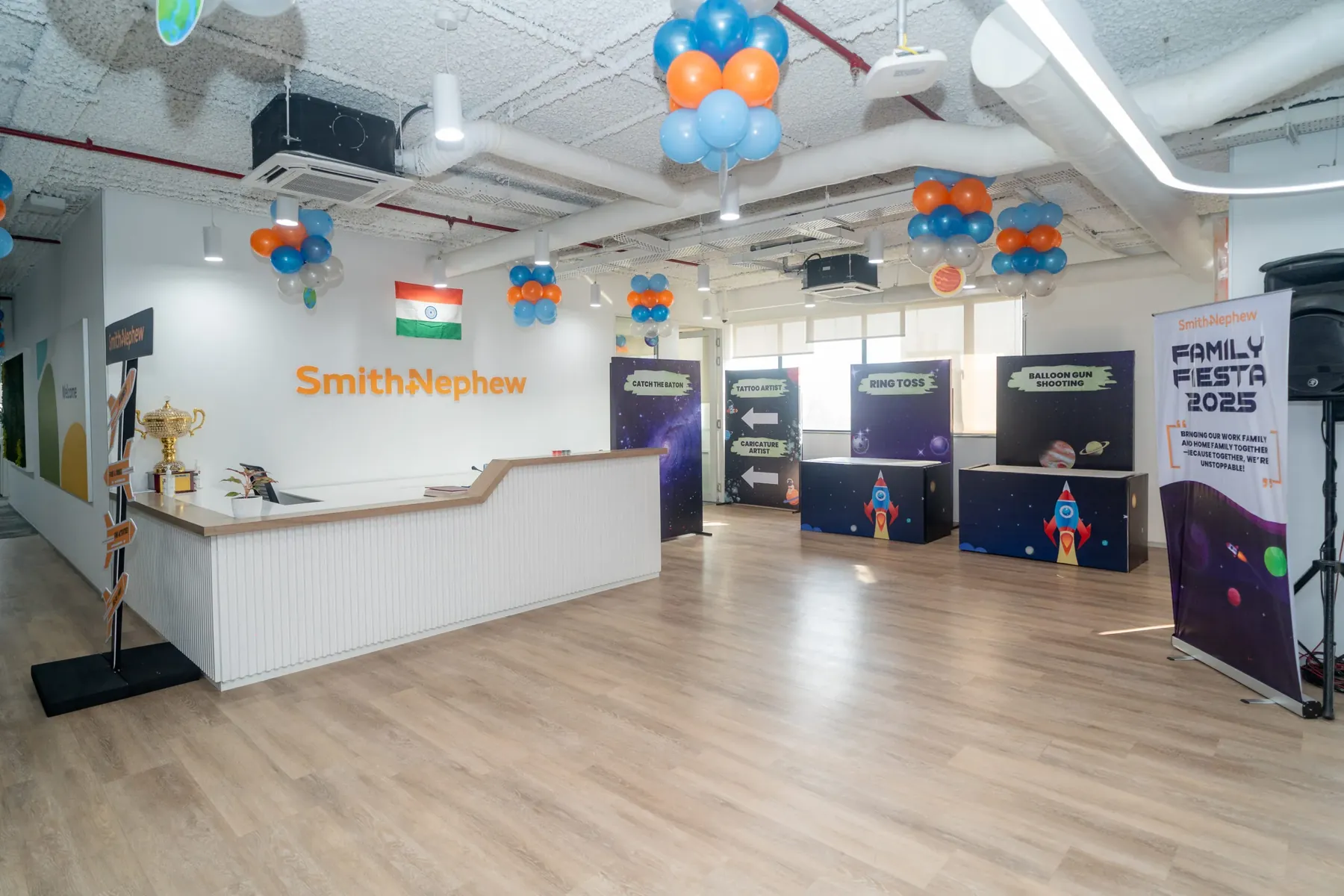 An office decorated with balloons and space-themed game booths for Family Fiesta 2025.