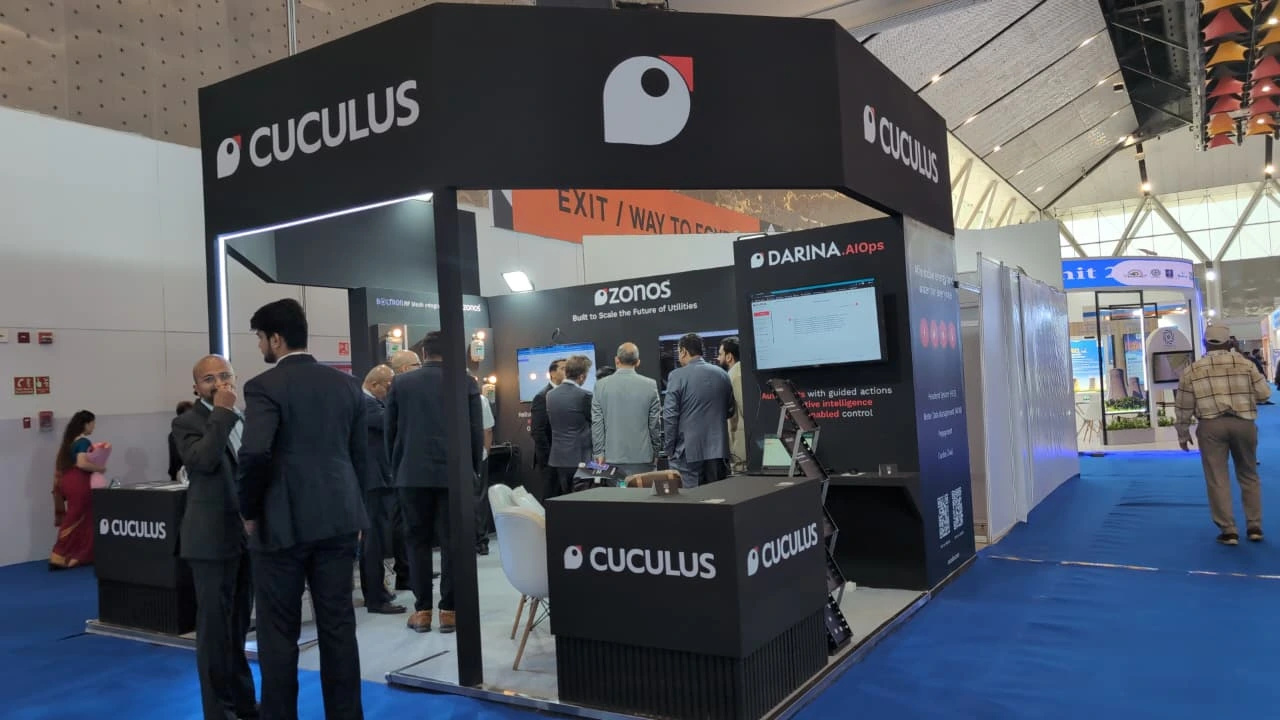 A black Cuculus branded exhibition booth with Zonos and Darina Edge signage and visitors at a trade show.