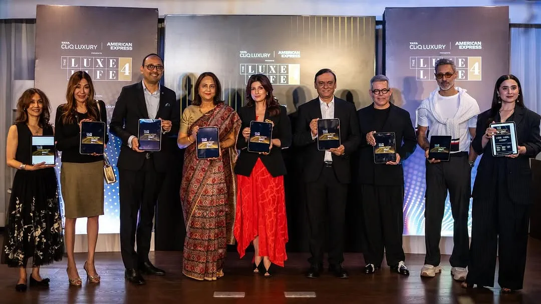 Well-dressed guests hold tablets at the Tata CLiQ Luxury and American Express Luxe Life 4 launch.